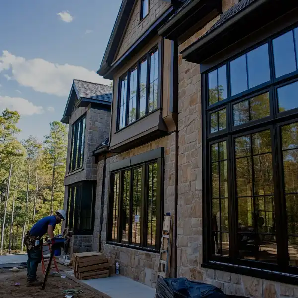 photo of a man working on home exterior windows